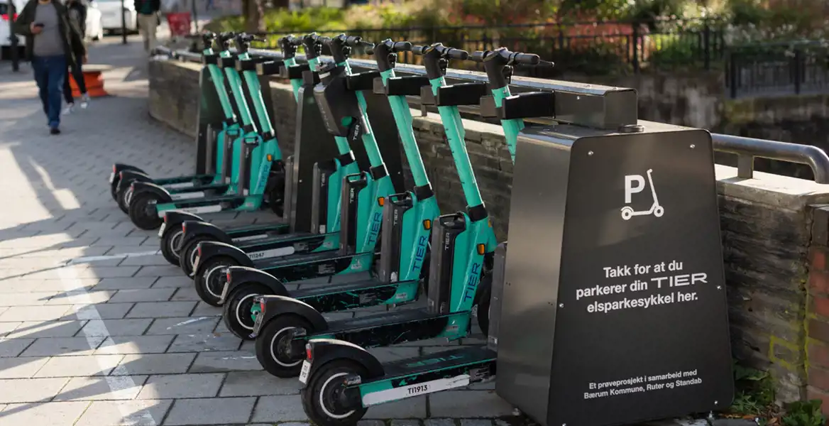 Shared scooters docked in Standab charging stations in Bærum