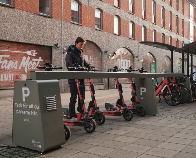 Voi scooters docked in Standab charging parking infrastructure in Gävle