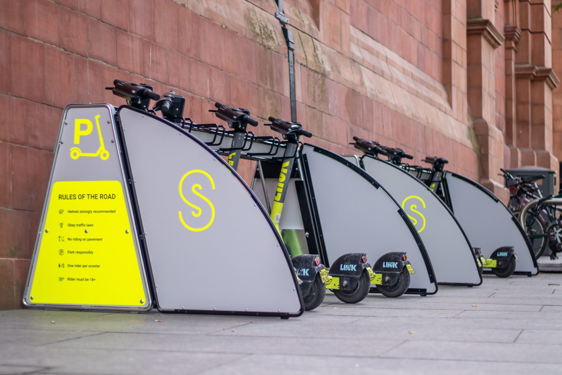 Superpedestrian e-scooters parked in modular parking stations in Nottingham