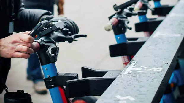 Shared scooter being docked in Standab charging infrastructure