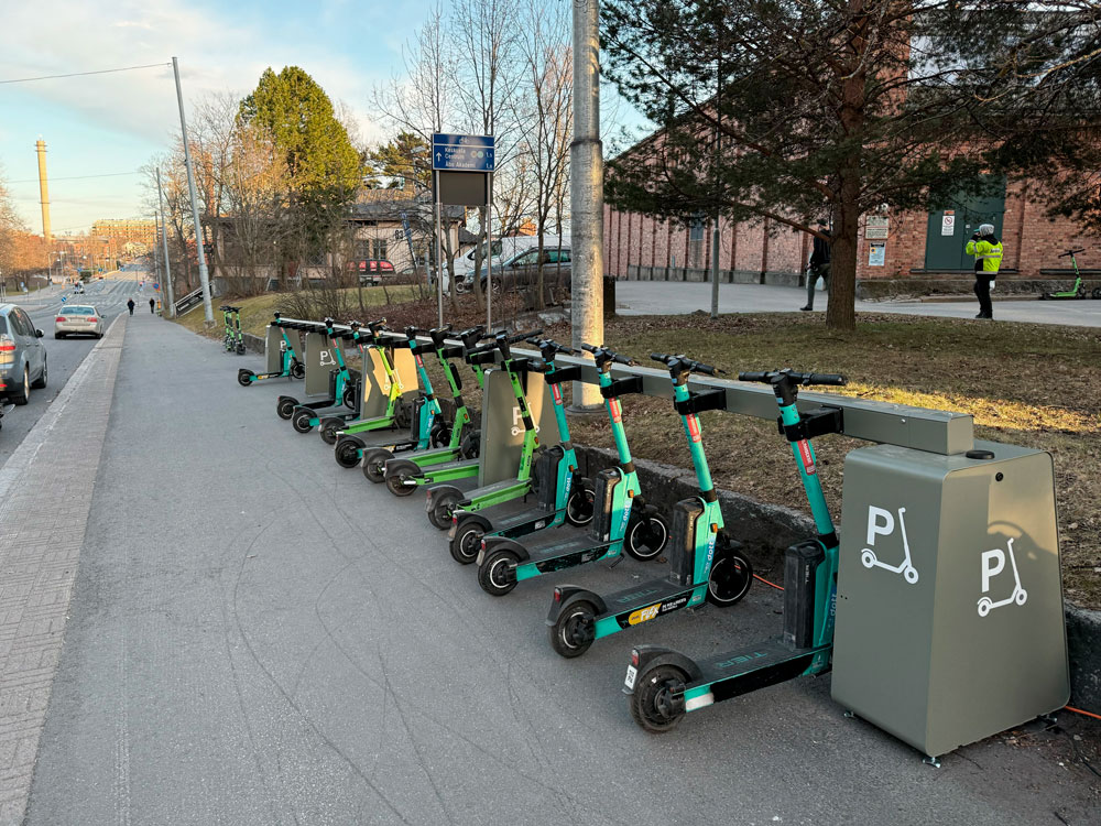 Shared e-scooters docked in Standab charging parking infrastructure in Vasa