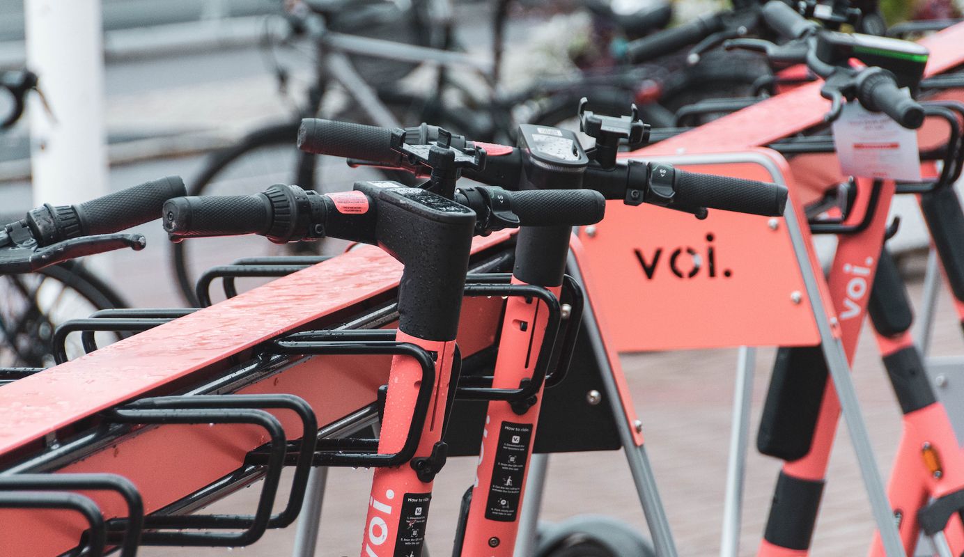 Voi e-scooters parked in dedicated physical parking infrastructure